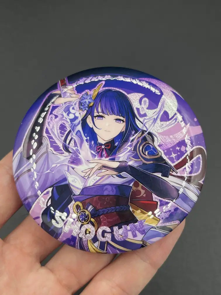 Raiden Shogun Genshin Impact Anime Badge – Held in Hand, Showing Size and Detail | The Void Vault