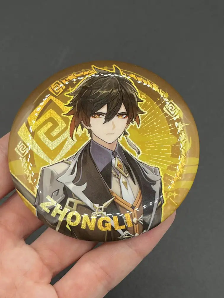 Zhongli Genshin Impact Anime Badge – Held in Hand, Showing Size and Detail | The Void Vault